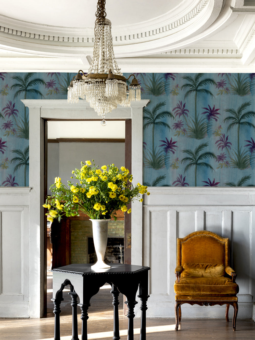 Tropical palm leaf wallpaper on blue wall with purple and green foliage