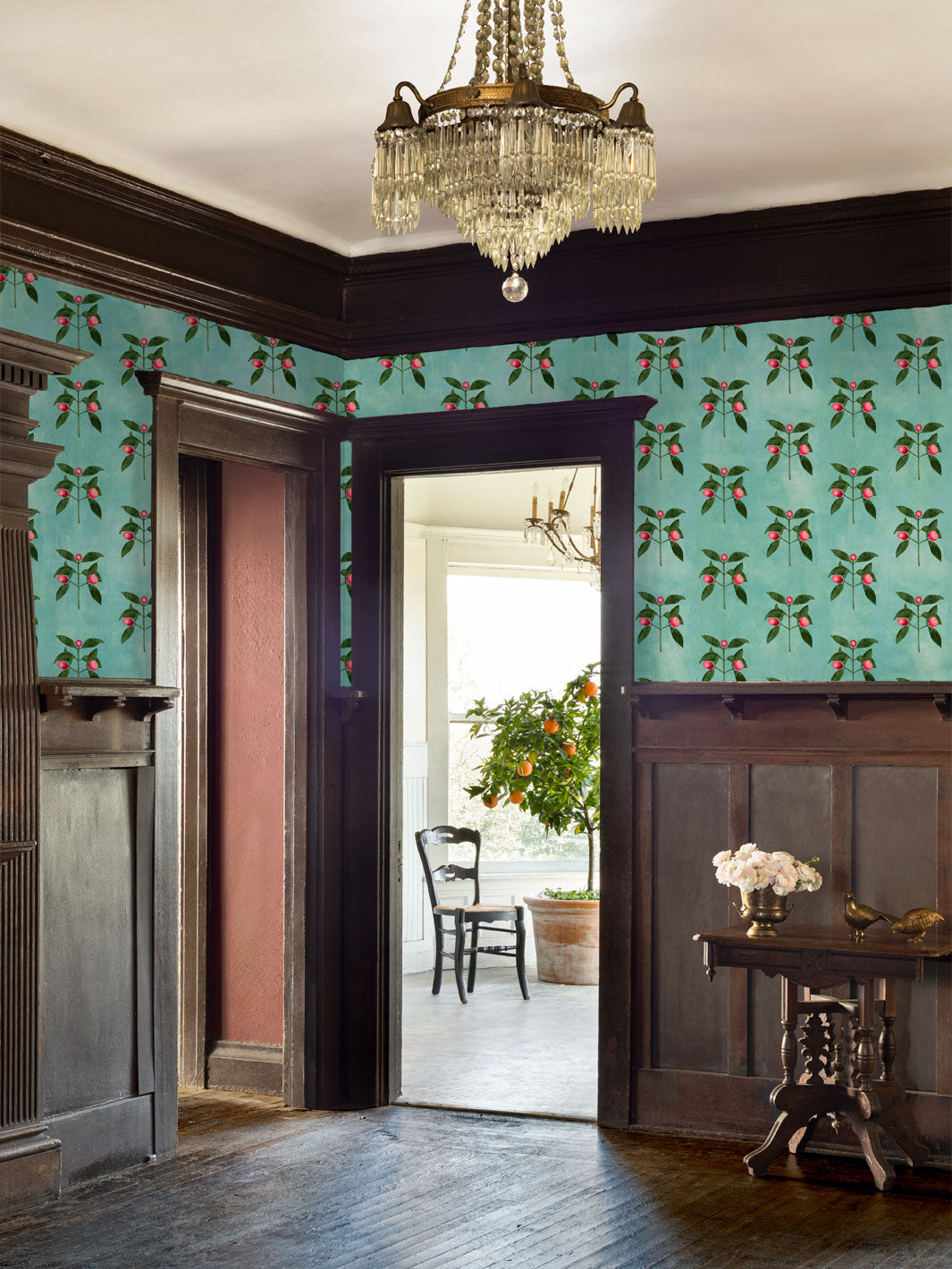 Wallpaper border in aqua blue with raspberry vine pattern across interior wall