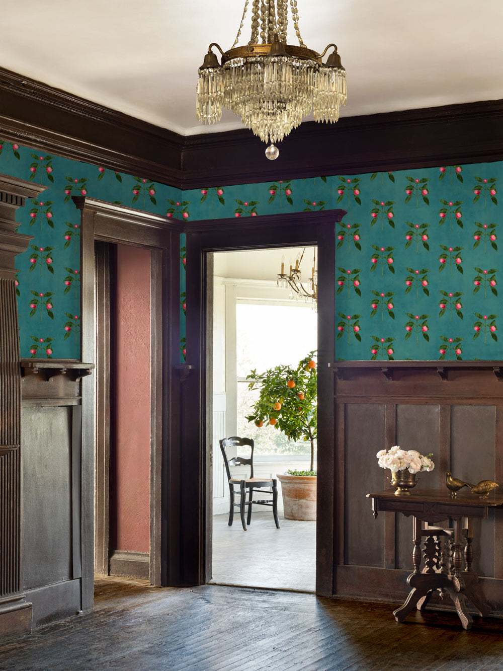 Botanical wallpaper covering walls with pink berry florals and green vines