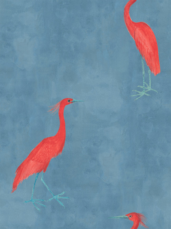 Red egret wallpaper pattern with multiple red birds on a blue background