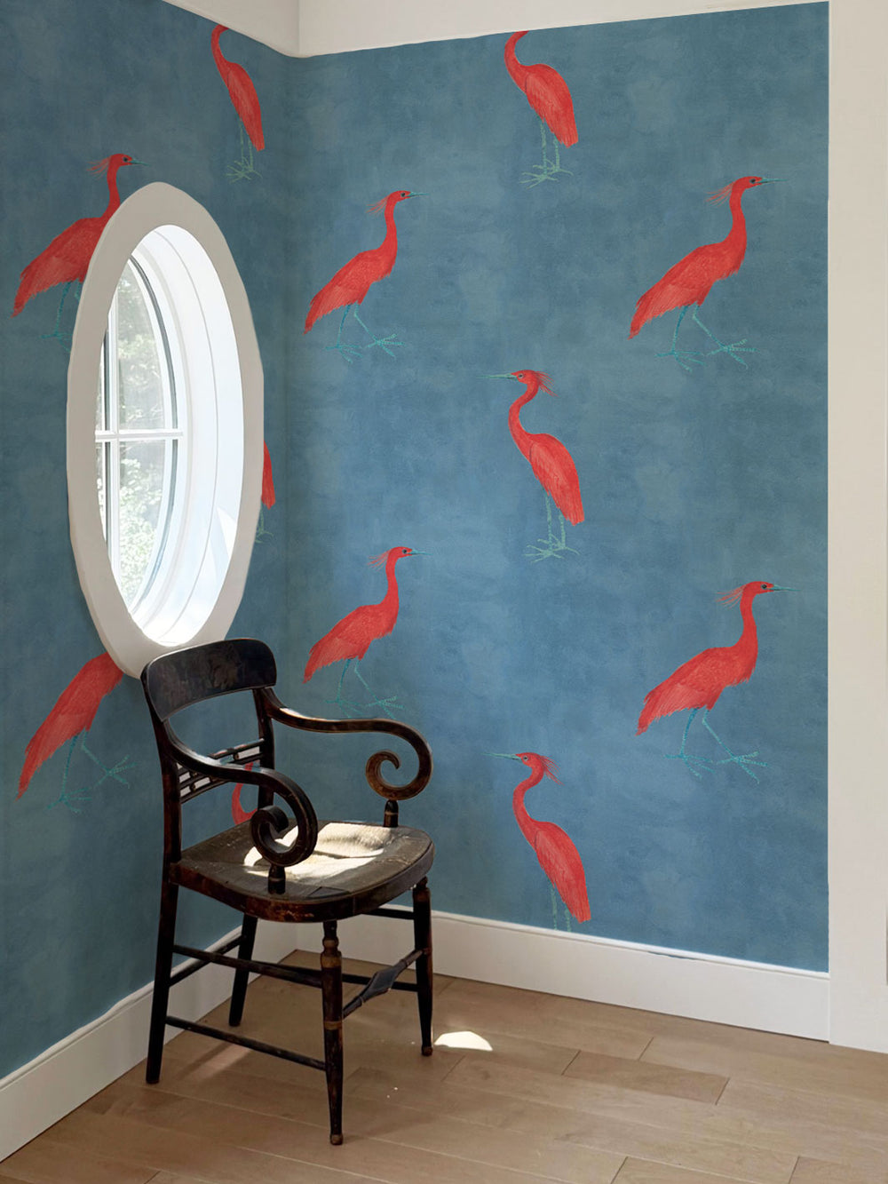 Wallpaper with scattered red egret birds on a blue wall