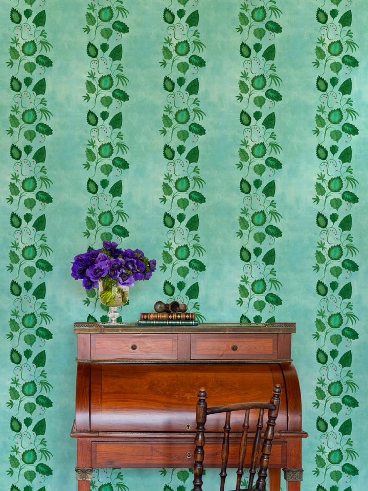 Botanical wallpaper with repeating green leaf and flower motifs on an aqua background