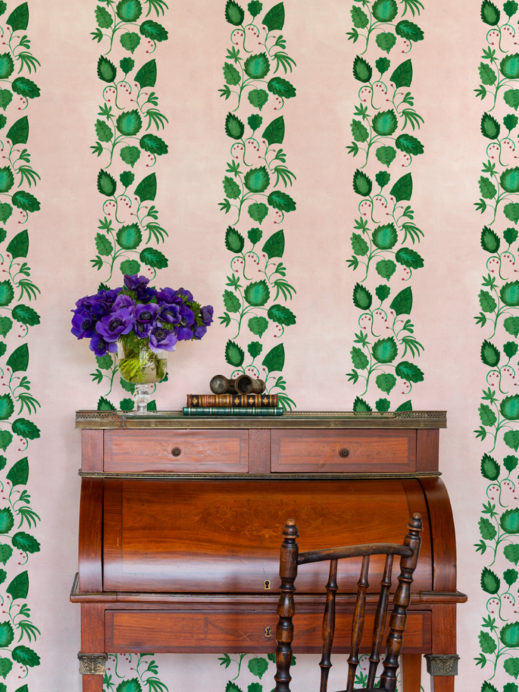 Botanical wallpaper with repeating vertical vine stripes in green and blush pink