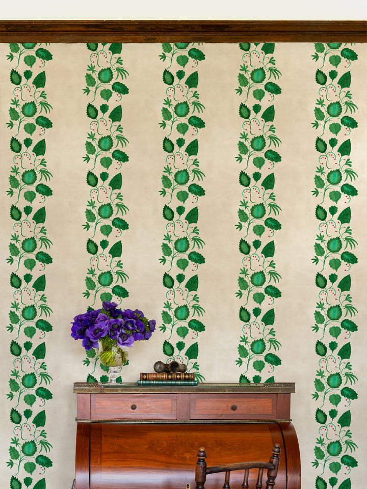Botanical wallpaper with repeating vertical vines and pears stripe pattern on a wall