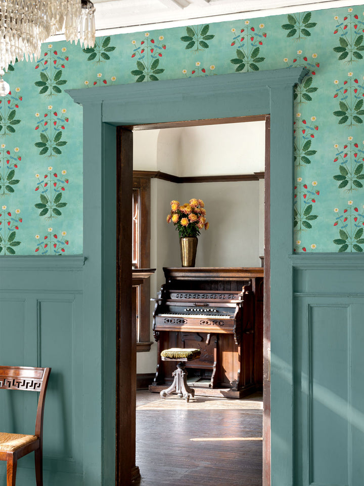 Aqua blue strawberry wallpaper around doorway with red berries, white flowers, green leaves
