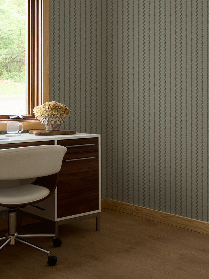 Grey-green fern stripe wallpaper in a home office with walnut desk and dried hydrangeas