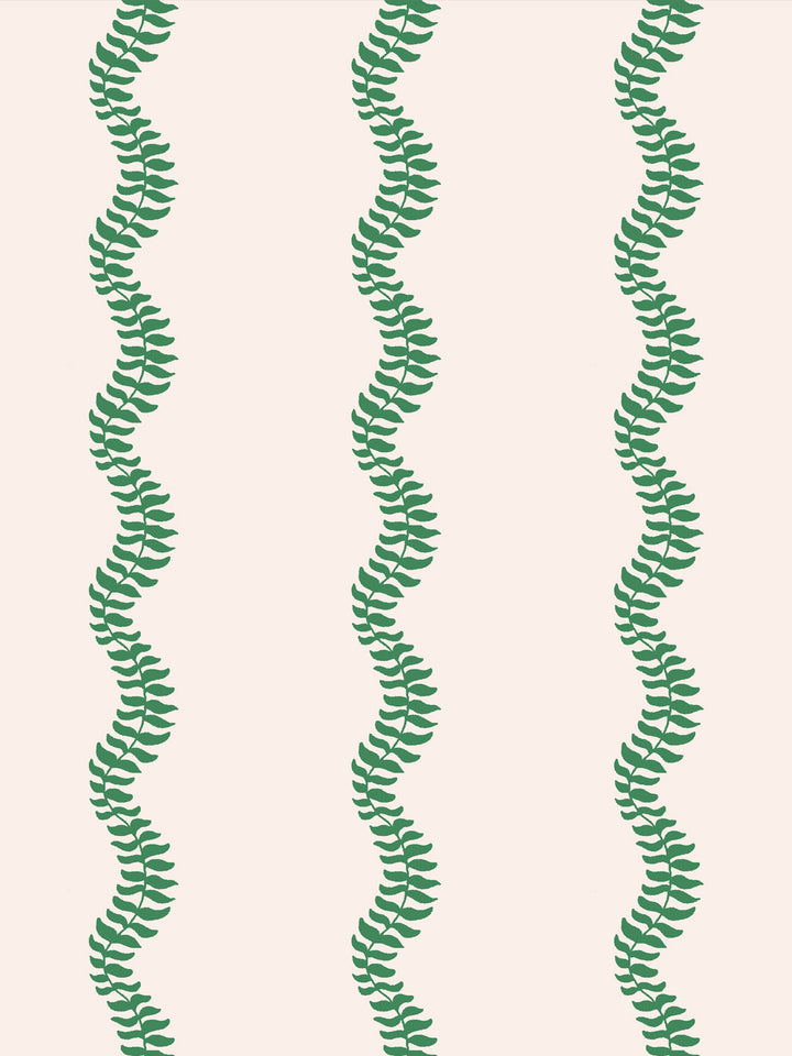 Close crop of bright kelly emerald green leaf stripes on warm cream