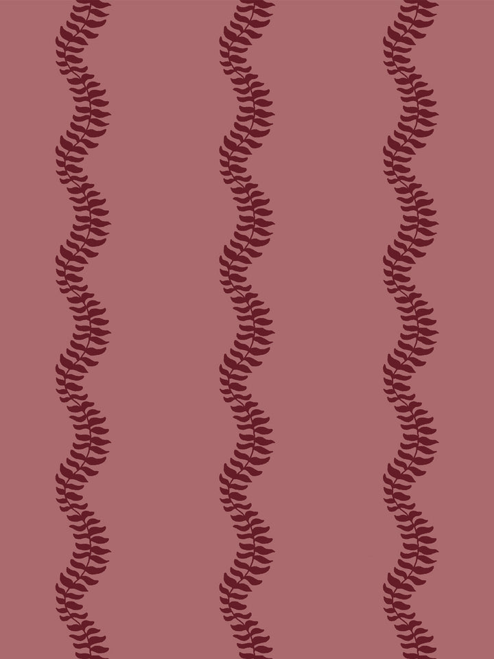 Close crop of deep garnet wine red leaf stripes on dusty rose pink