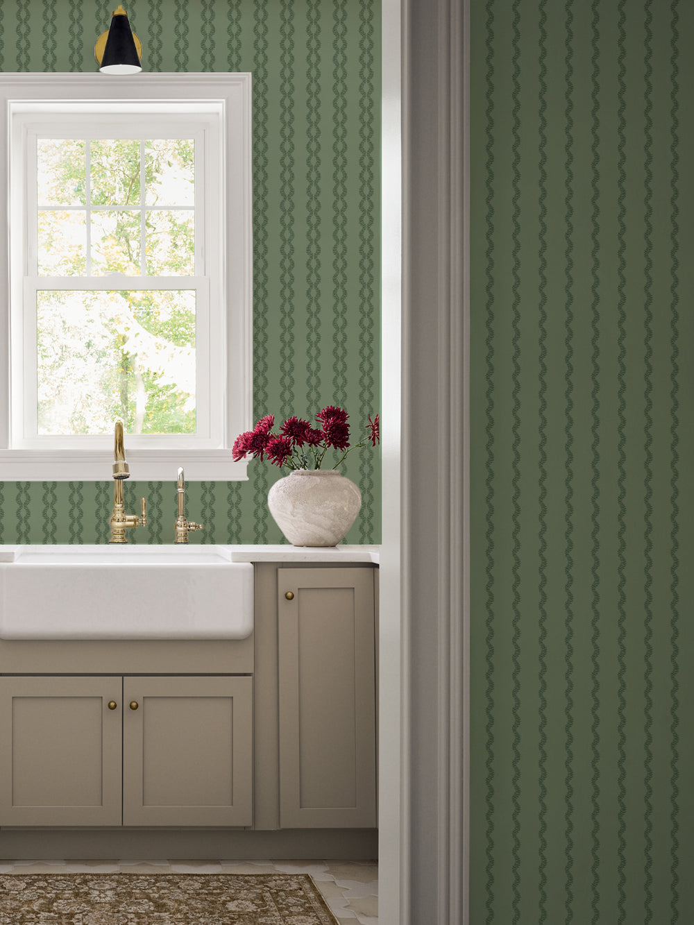 Antique Leaf Sutton Vine kitchen wall with farmhouse sink, brass faucet and taupe cabinets