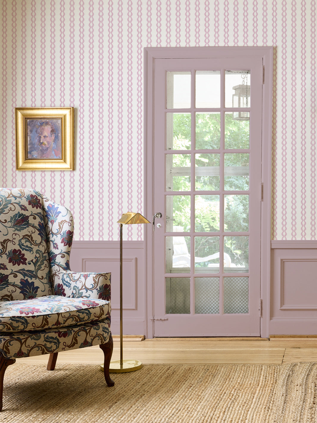 Antique Mauve Sutton Vine wall with a floral wingback chair, brass lamp and lilac French door