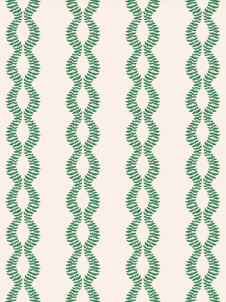 Close crop of saturated kelly or emerald green leaf vines on warm blush-cream off-white