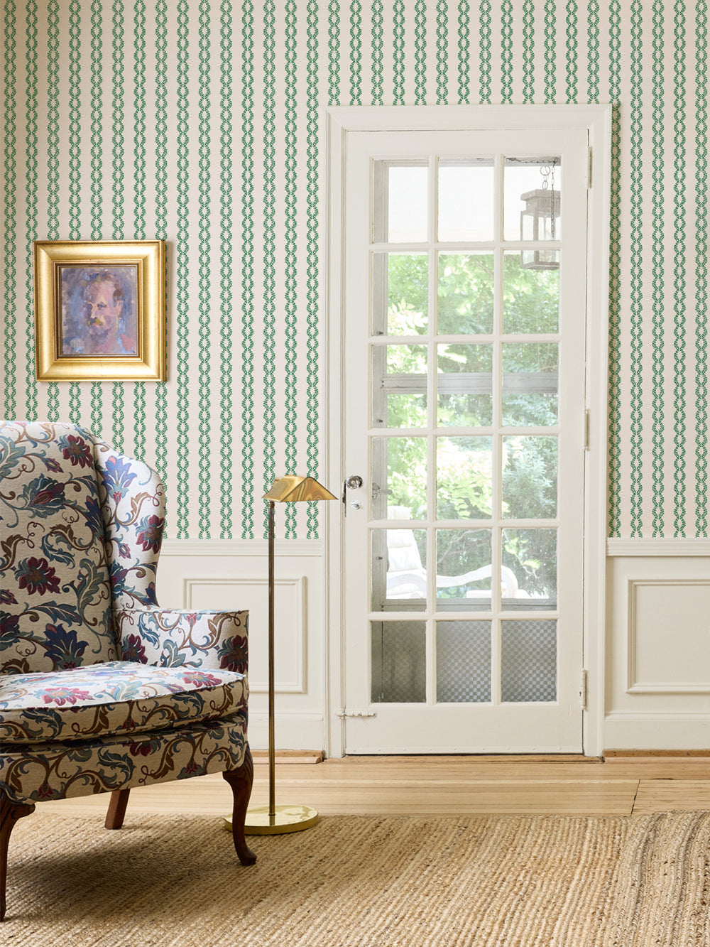 Evergreen Cream Sutton Vine wall with a floral wingback chair, brass floor lamp and white French door