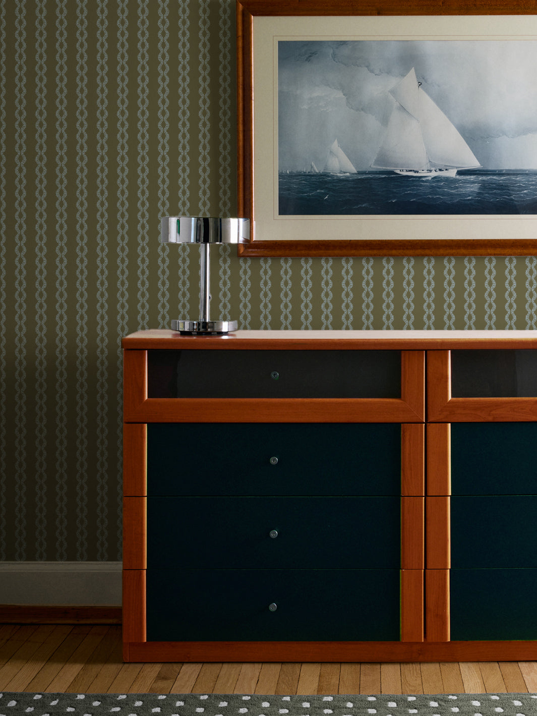 Fern Sky Sutton Vine wall above a teal and wood dresser with chrome lamp and sailing yacht print