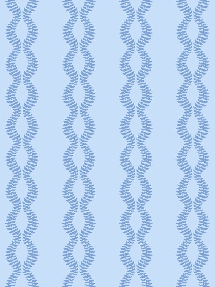 Close crop of medium cornflower or denim blue leaf vines on pale sky blue