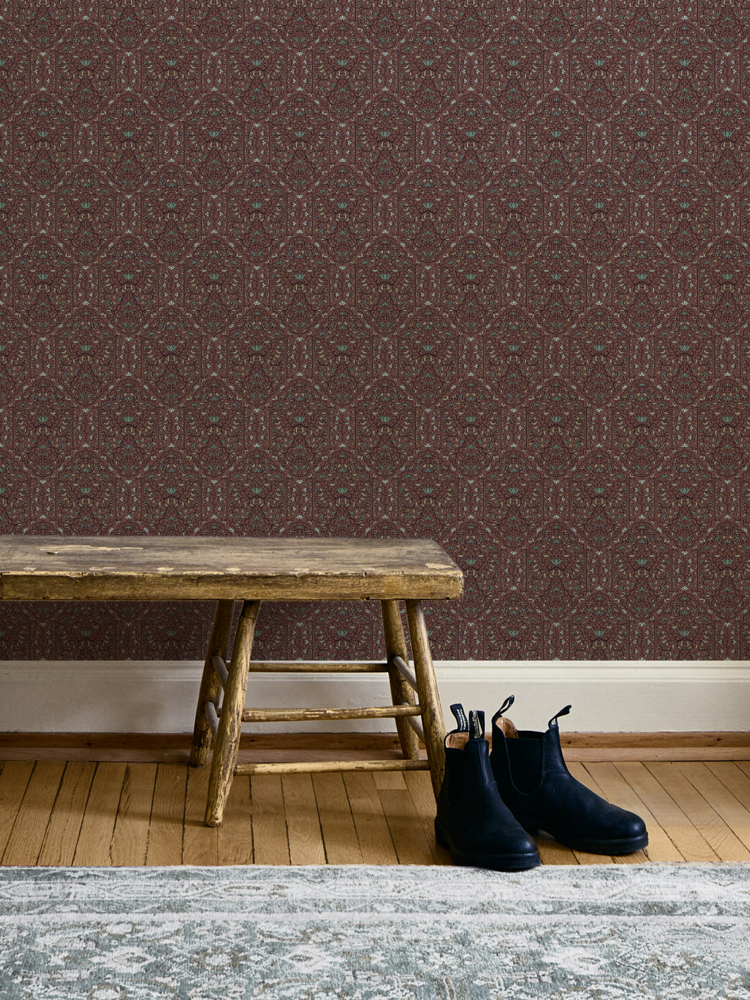Entryway with Faded Bordeaux Taliah Large wallpaper, weathered wood bench and black boots