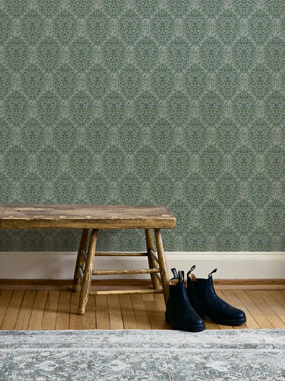 Entryway with Overcast Garden Taliah Large wallpaper, rustic wood bench and black Chelsea boots