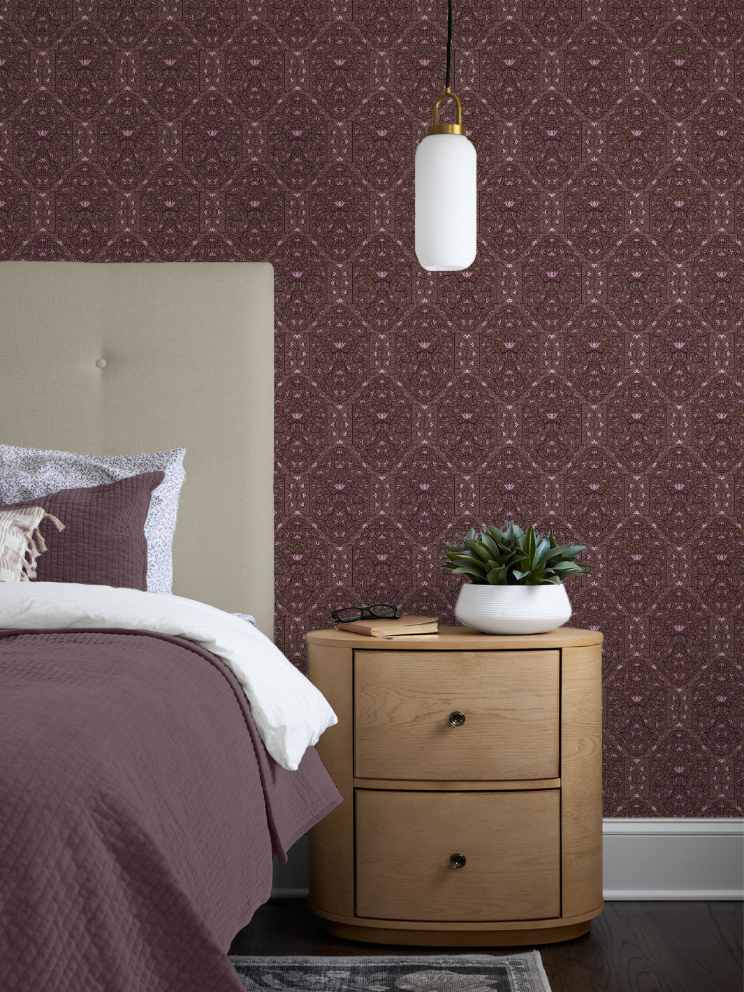 Bedroom with Soft Camellia Walnut Taliah Large wallpaper, cream headboard, plum quilt and oak nightstand