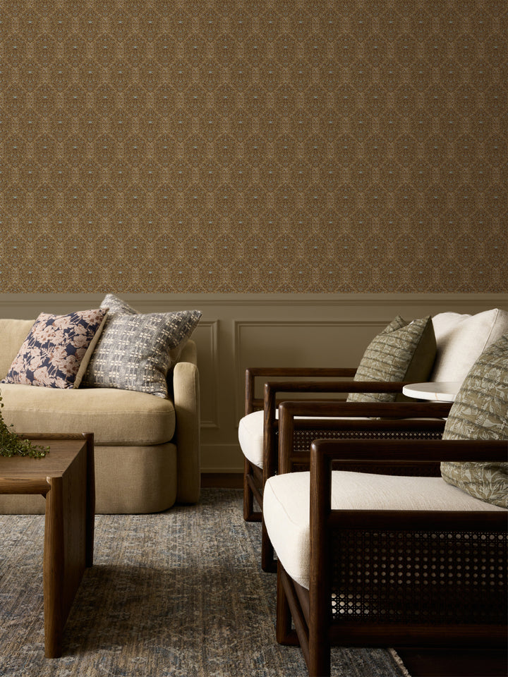 Tan and brown Taliah wallpaper above panelled wainscot with a beige sofa and cane armchairs