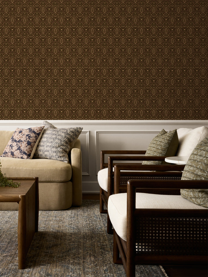 Dark brown Taliah wallpaper above white wainscot with a beige sofa and cane armchairs