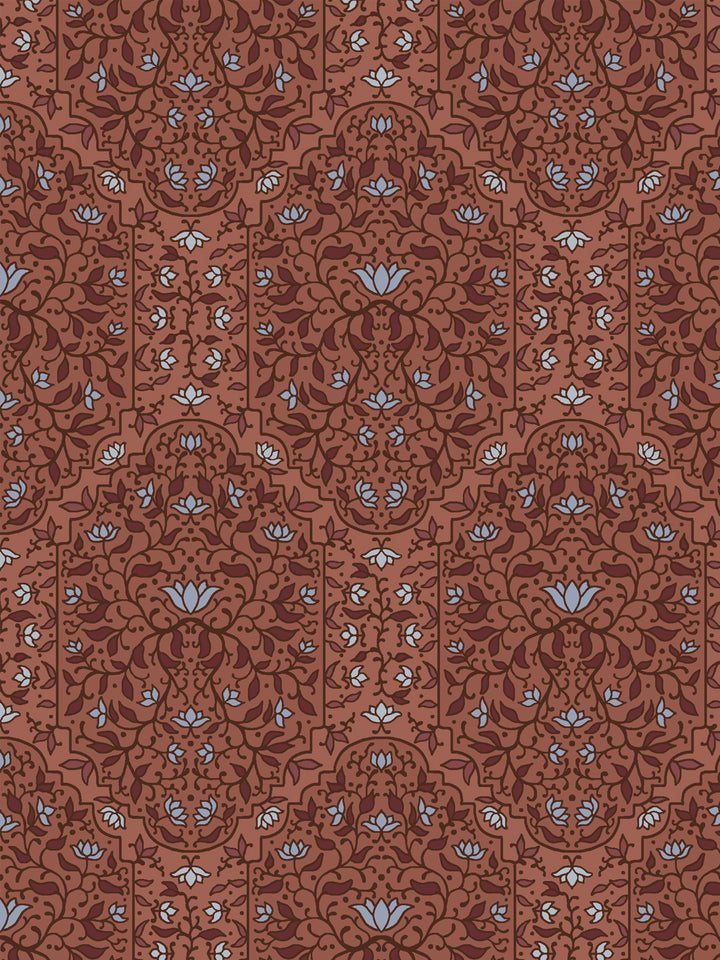 Close crop of deeper maroon-brick and foliate arches on terracotta brick