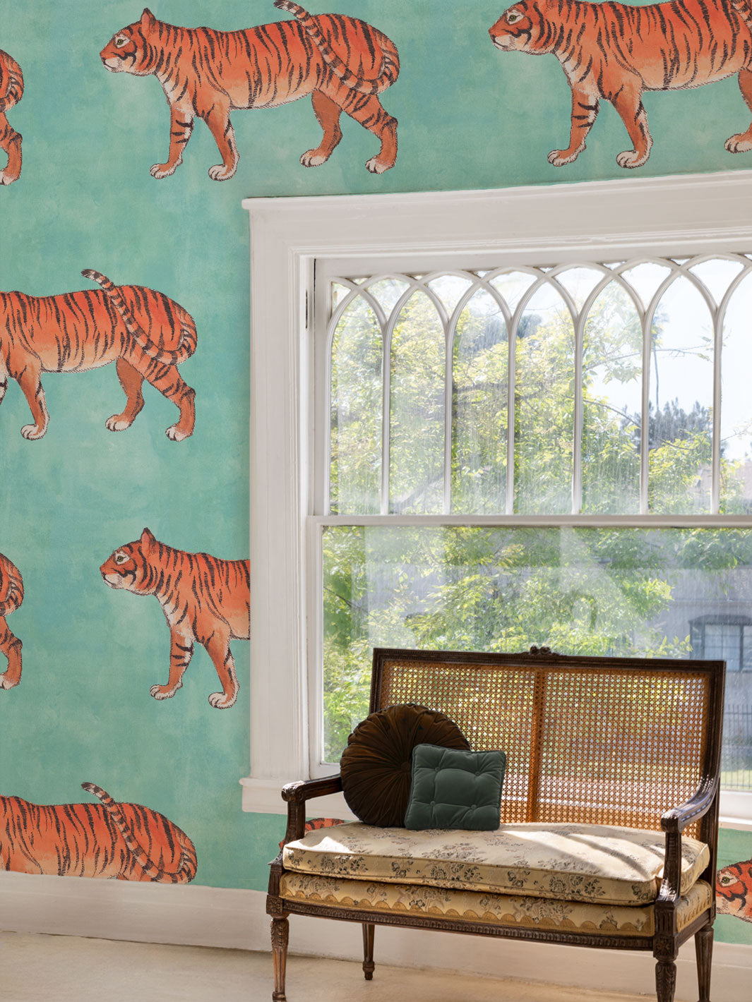 Tiger wallpaper pattern on wall with repeated orange striped tiger illustrations.