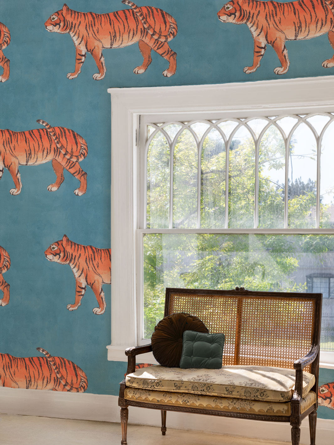Tiger pattern wallpaper on a wall with repeating orange striped cats