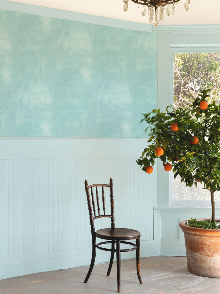 Blue watercolor textured wallpaper on wall with soft mottled finish