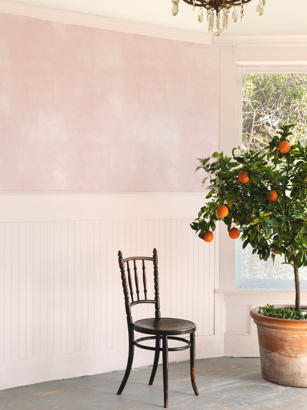 Blush washes wallpaper on interior wall with subtle mottled pattern