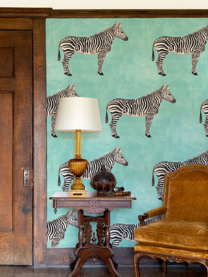 Zebra pattern wallpaper with multiple black-and-white zebras on aqua blue background