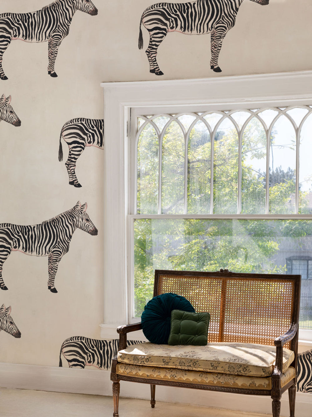 Zebra print wallpaper on an ivory wall with small repeating zebra silhouettes