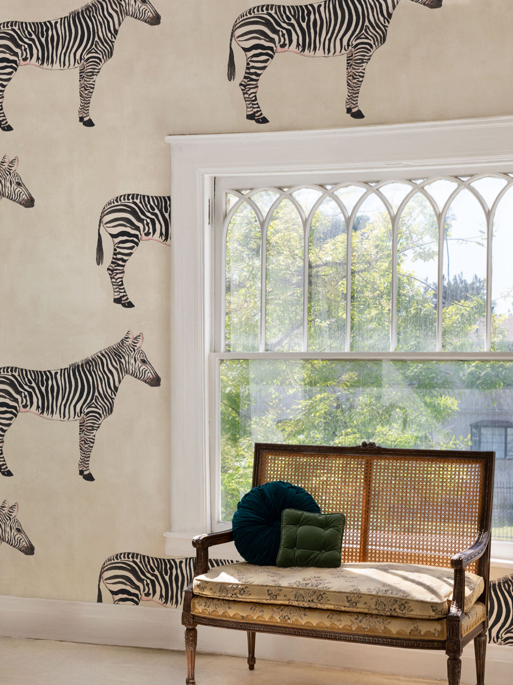 Zebra print wallpaper with scattered zebras on parchment beige wall