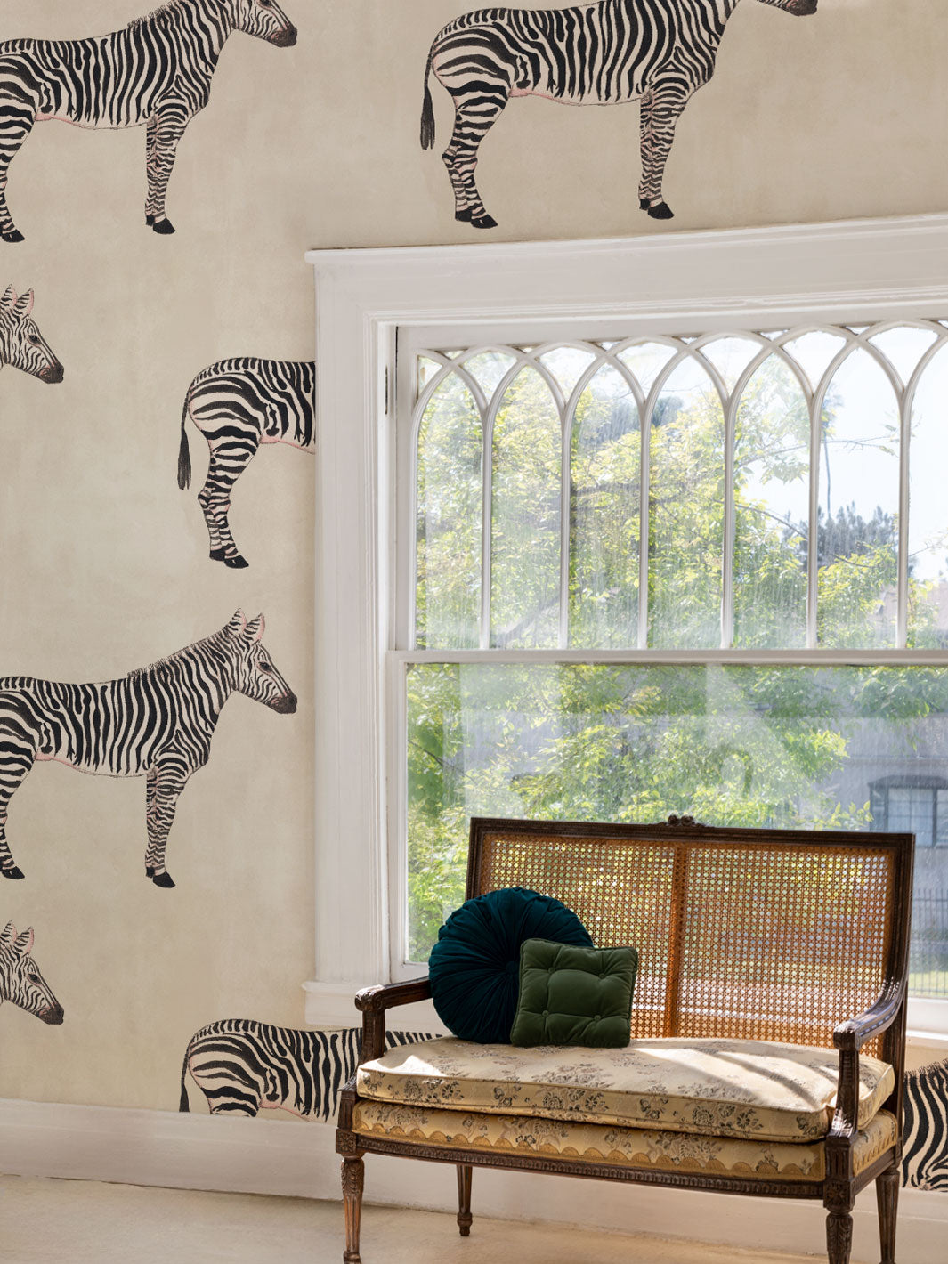 Zebra print wallpaper with scattered zebras on parchment beige wall