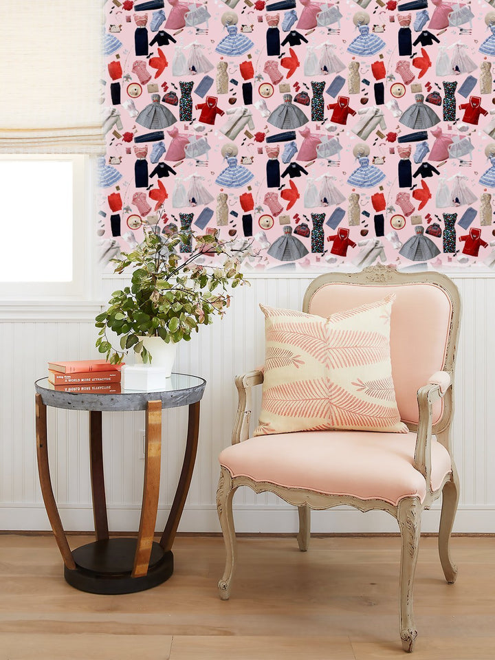 Wallpaper on wall with scattered fashion-doll outfits, hats, and shoes pattern